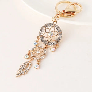 Silver tone dream catcher keyring with bead and feather detail